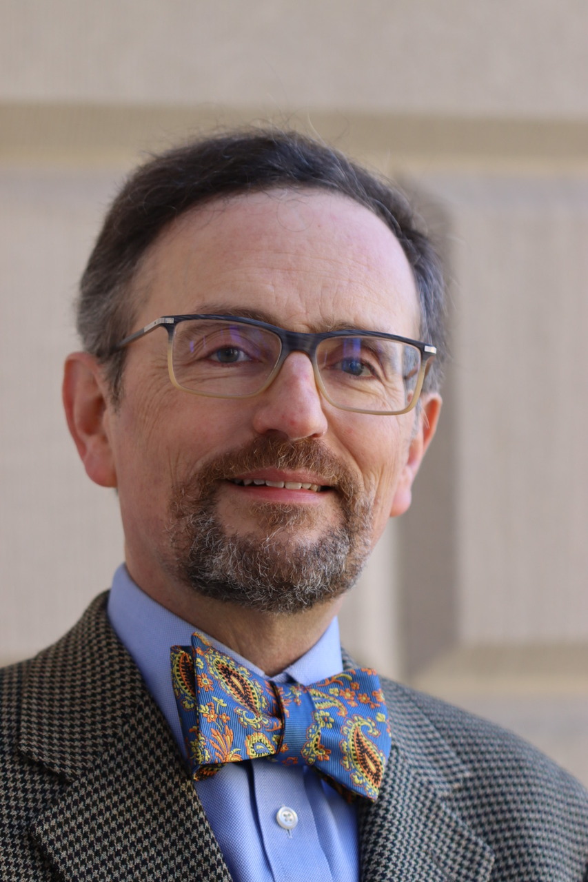 Image of Dean Grodzins in a bowtie, smiling